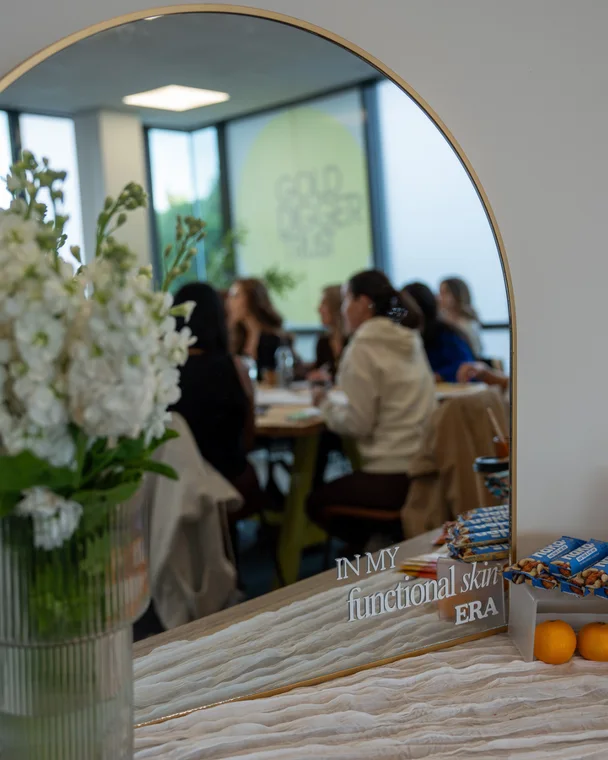 The room at the FSA event, reflected in a mirror reading in my functional skin era